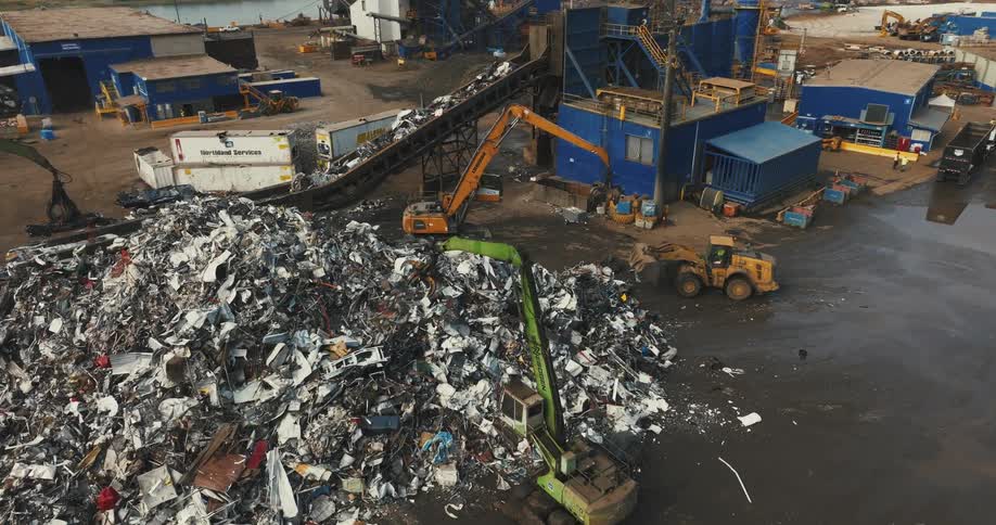 Dump trucks move piles of trash in a landfill