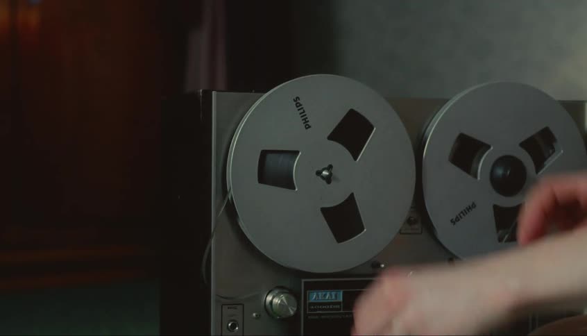 A person puts the reel on the machine