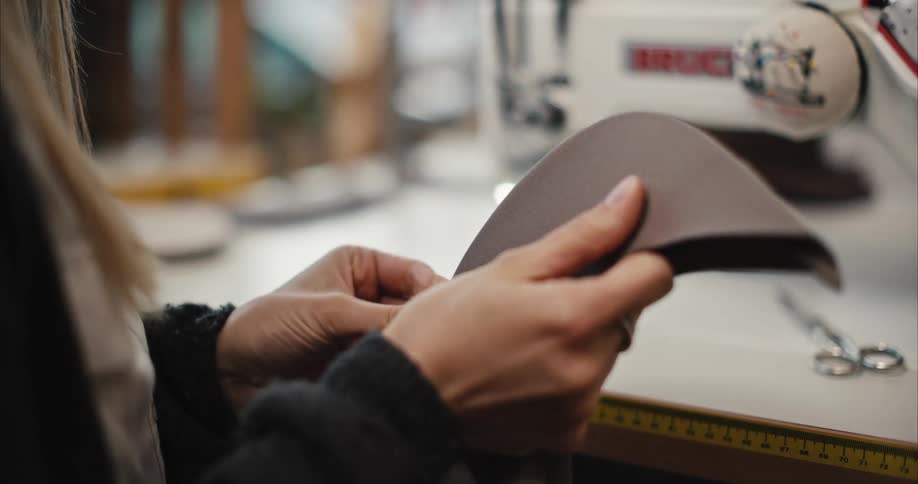 A tailor is working in the shop