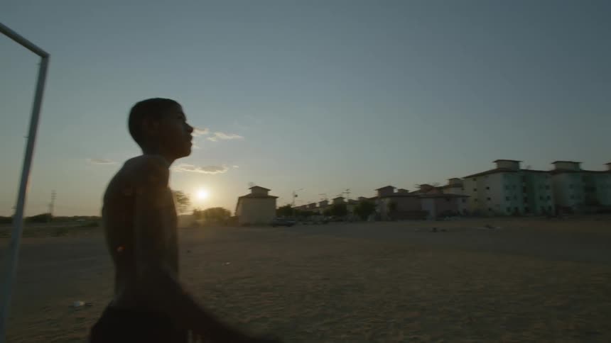 A child throws the soccer ball down the field