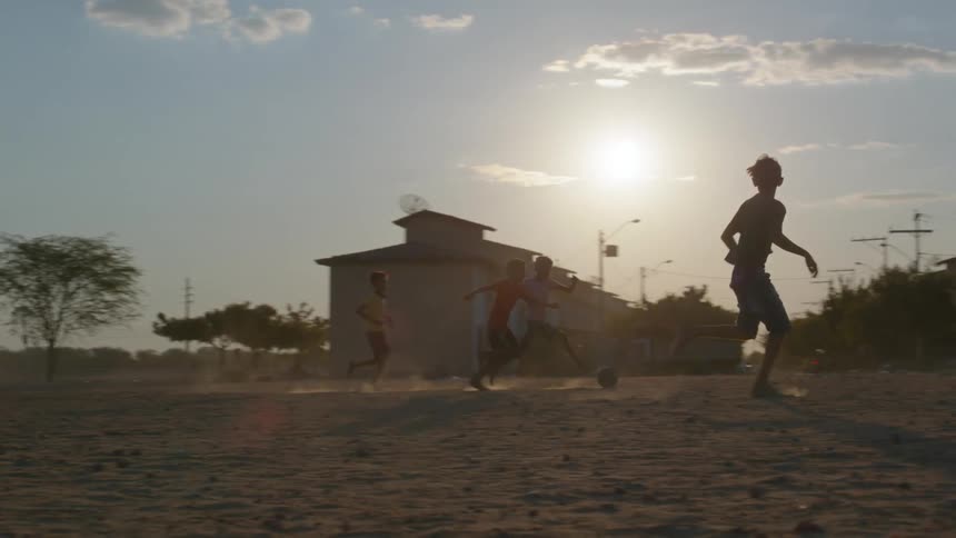 Children are playing soccer outside