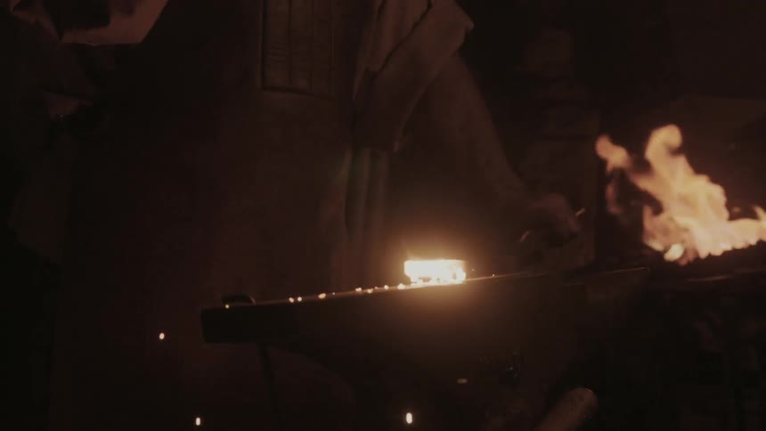 A blacksmith hammering a piece of red-hot iron