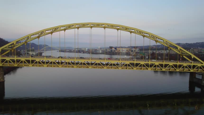 Cars driving across a arched bridge