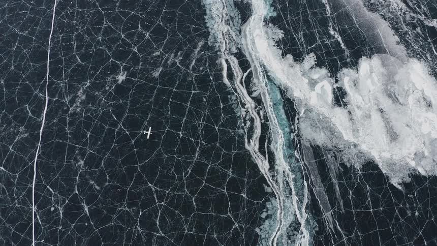 An aerial view of an airplane on frozen lake