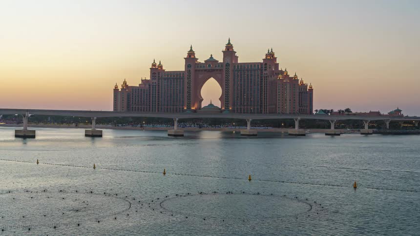 Atlantis the palm dubai resort with colorful water fountains and building lights glowing from morning to night