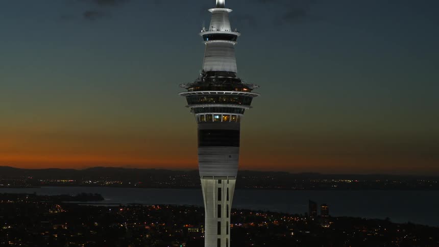 The tall tower is above the city