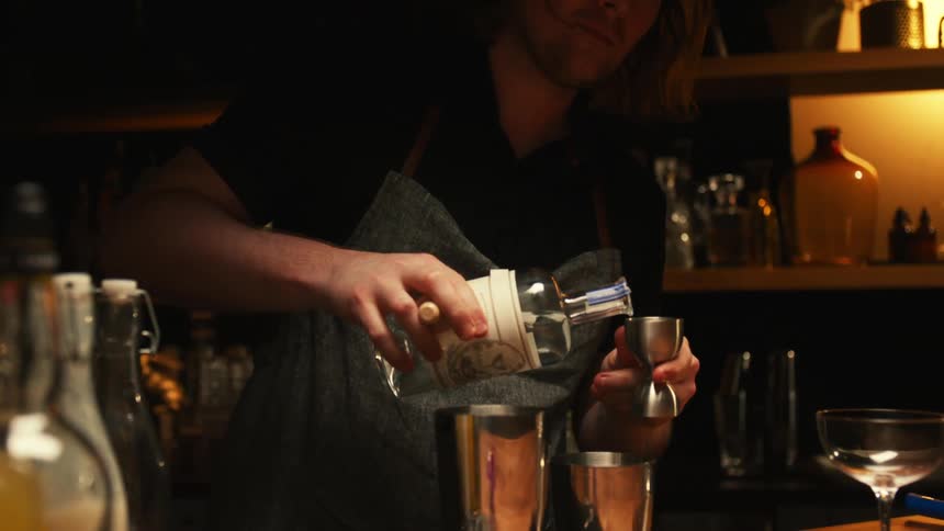 The bartender is serving drinks