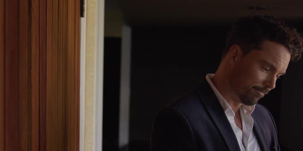 A man chats with someone before leaving his house