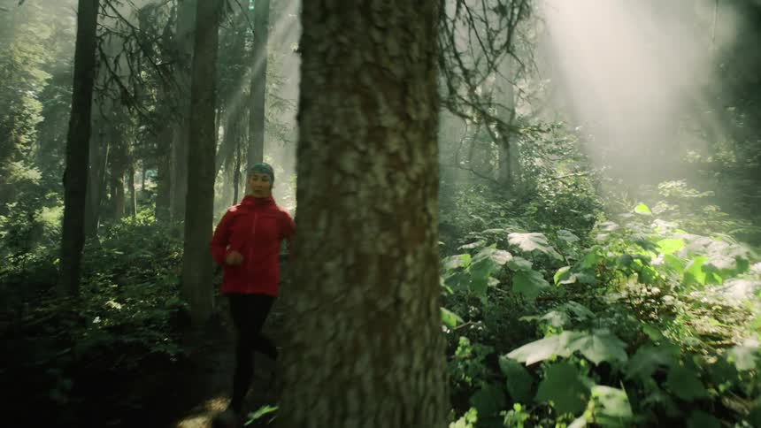 A woman runs through the forest