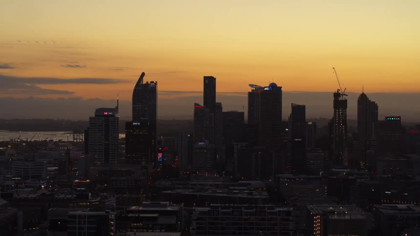 The city is dark at sunset