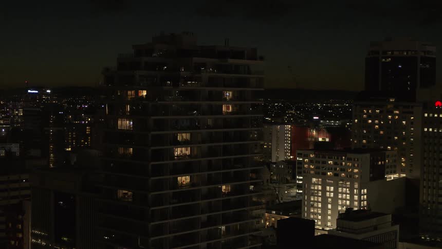 Lights are on in buildings and skyscrapers across town as they glow in the darkness
