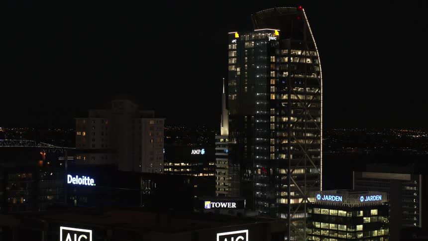 Lights are on in buildings and skyscrapers as signs across town glow in the darkness