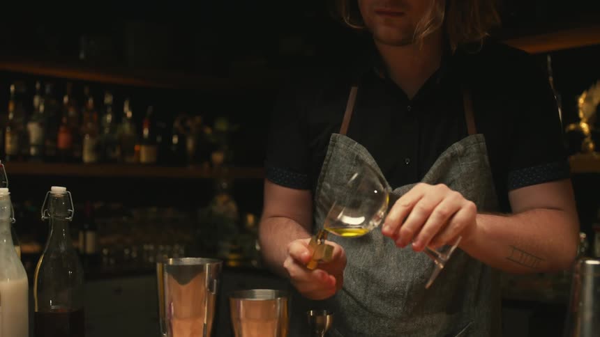A bartender is serving a drink