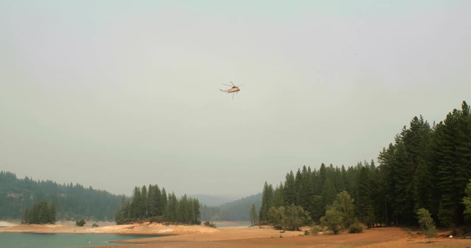 A helicopter is flying in the sky during day time