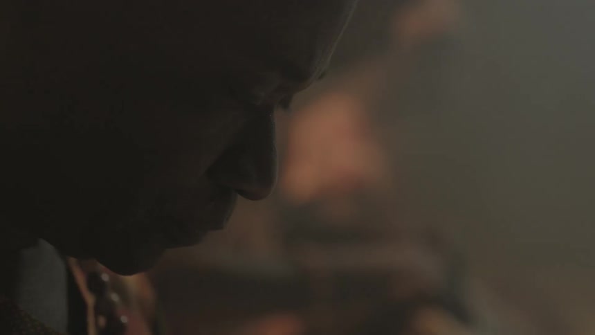A person is looking down in a dark area