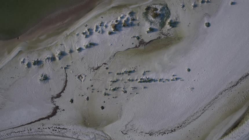 Snow covers the shore below