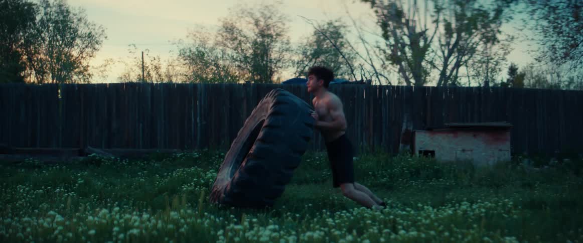 A man flipping tires for a workout