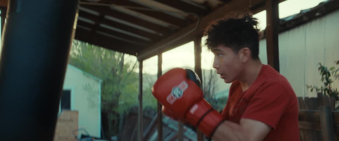 A view of a person boxing on a patio