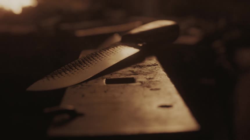Tools sit on a bench in a dark shop