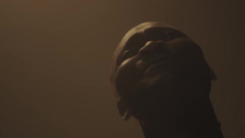 A man is singing as he looks up