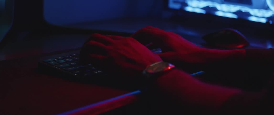 A man types on his computer keyboard