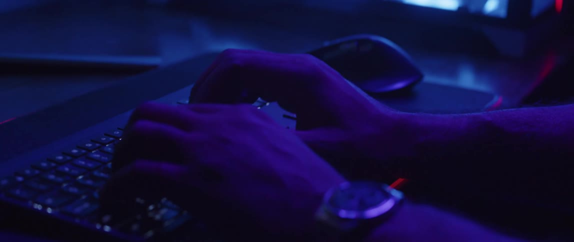 A man types on his computer keyboard