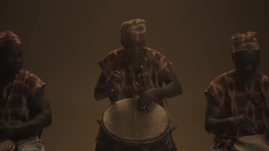 Three men playing bongos