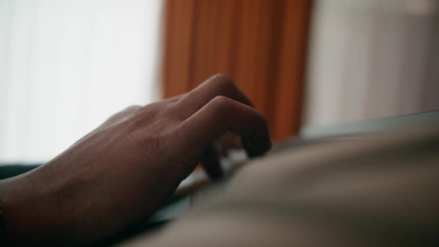 Mans hands typing on laptop keyboard