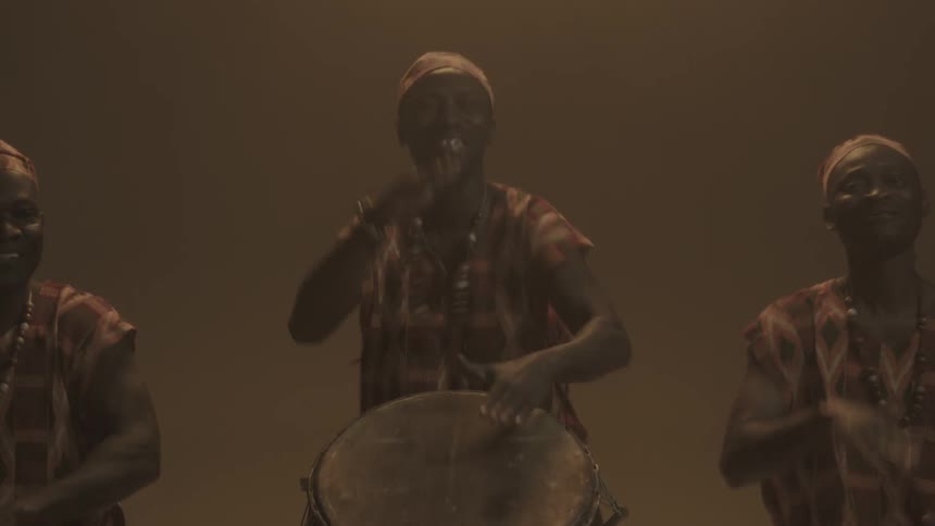 Three men playing bongos and clapping