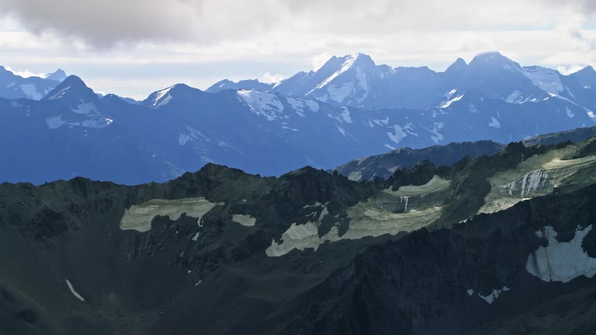 An aerial view of snowy mountains in the wilderness