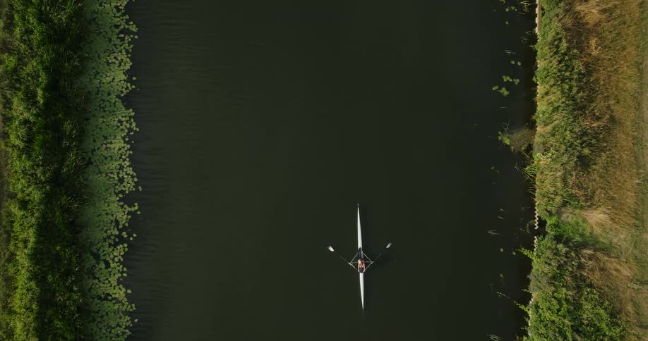 Birds eye view of a person rowing down a river