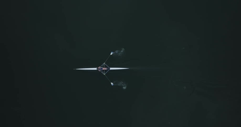 A person rowing a boat down a river