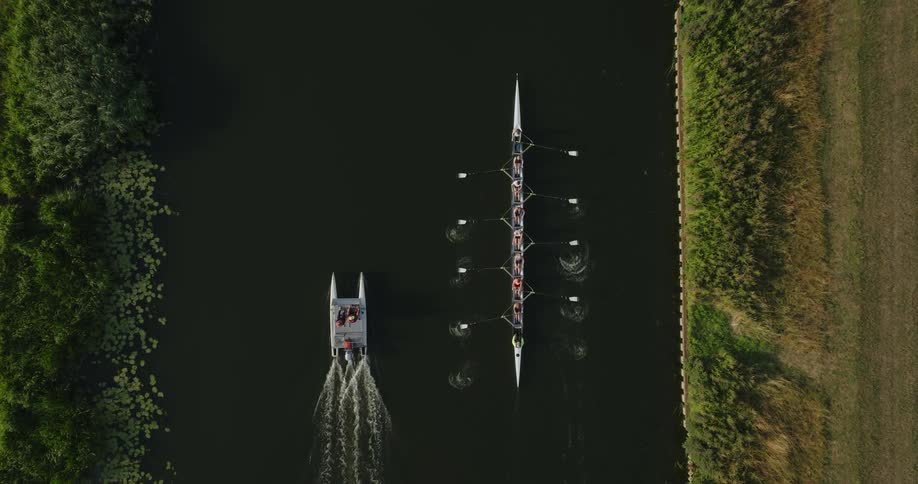 People are rowing training on a river