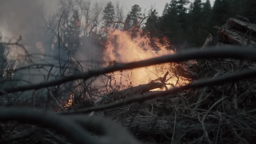 A large fire is burning on a cloudy day