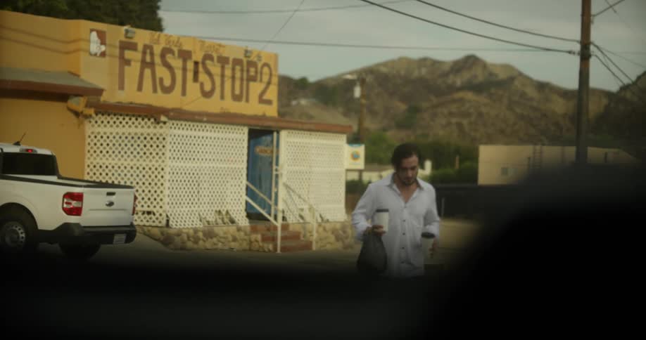Man carrying hot beverages buyed from a roadside shop on a small town