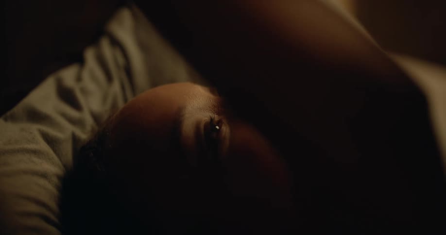 A couple kiss in bed