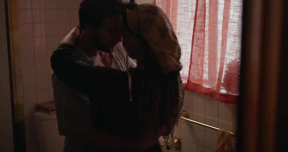A couple hug in the bathroom