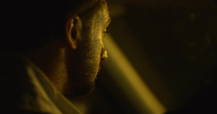 A man is driving at night