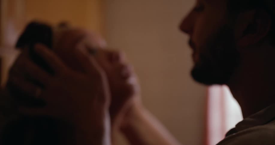 Man comforts crying woman and brings their foreheads together