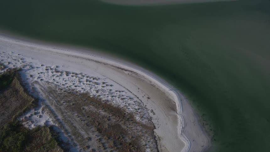 A large stretch of beach beside the water