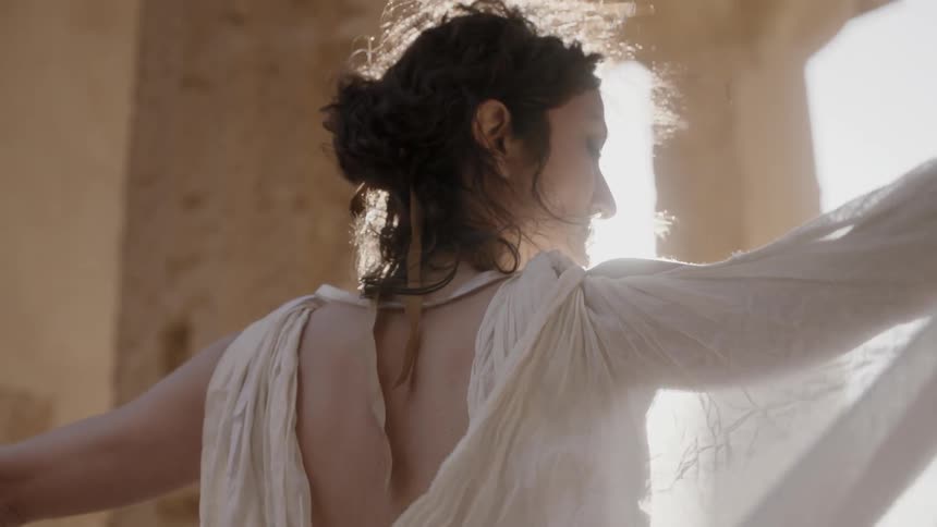 A woman's white dress flowing in the breeze