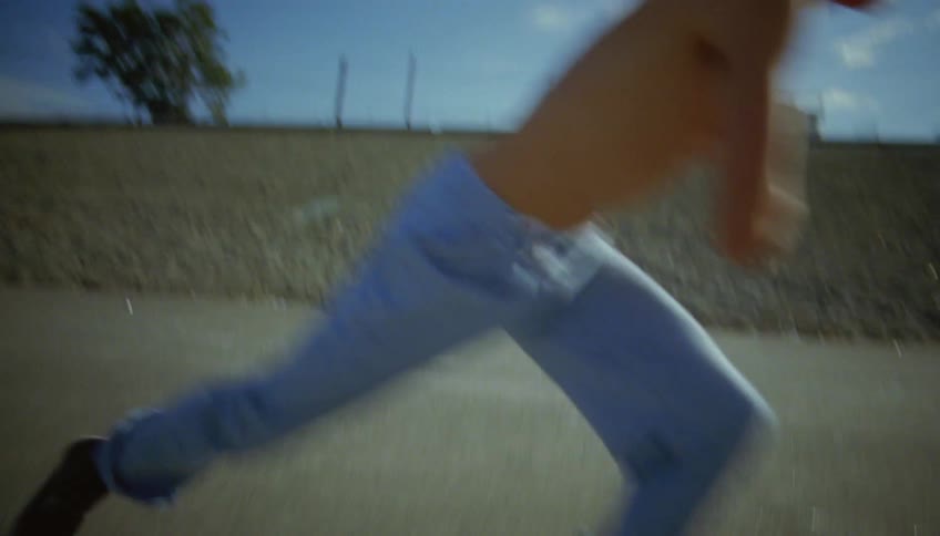 Shirtless male skateboarder skateboarding on road does a hard flip