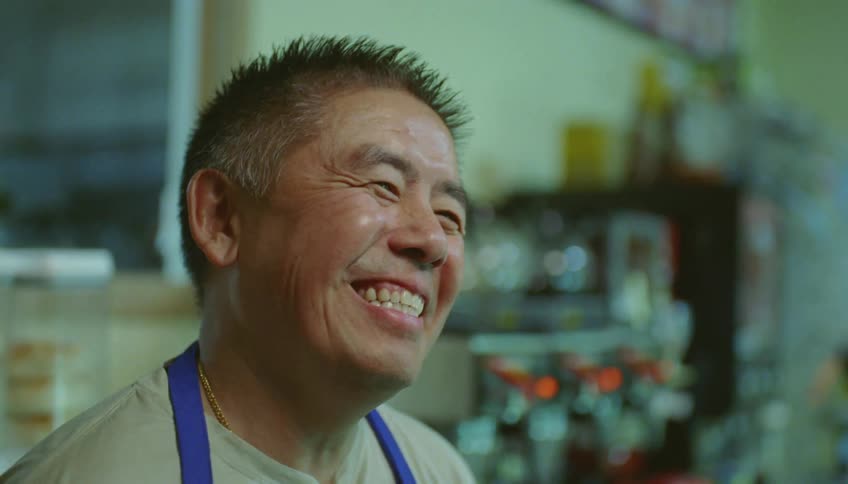 Two employees in a store talk and laugh together