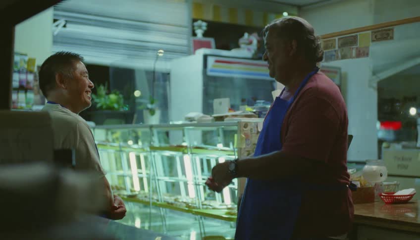 Coworkers talk and laugh inside the shop