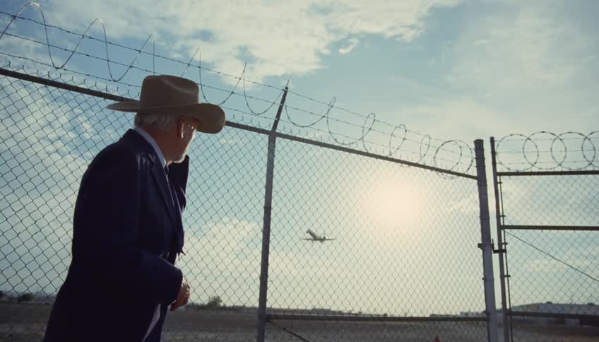 A man watches the plane fly over