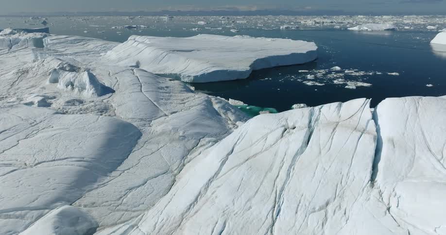Aerial view of large iceberg floating in sea