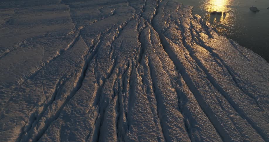 Aerial view of large glacier at sunset