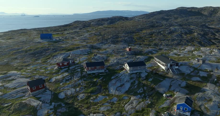 Colorful homes fill a sparse neighborhood on a cliff