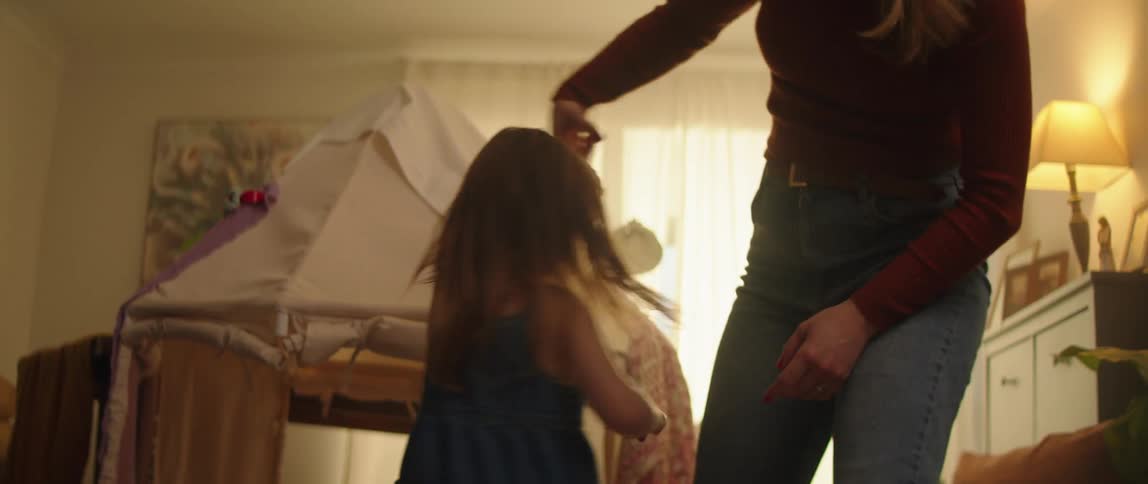 A mother is dancing with her children