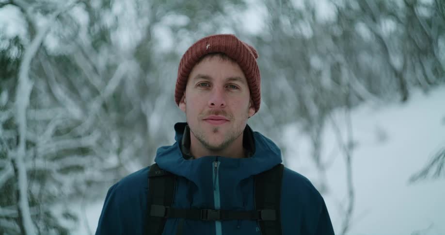 A portrait of a man standing in the snow